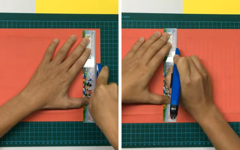 Dùng dao rọc giấy vừa đo vừa cắt từ đường kẻ vừa đánh dấu xuống dưới để tạo ra những đường thẳng song song với chiều rộng khoảng 1cm
