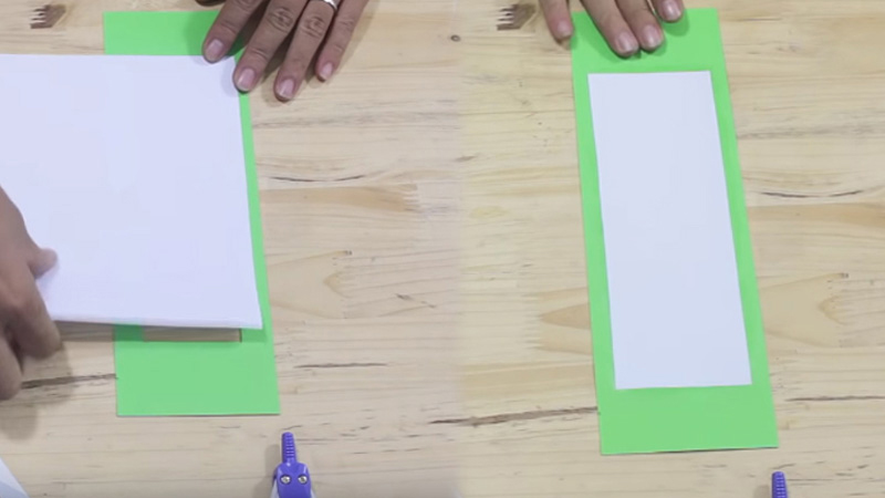 Dùng tờ bìa A4 màu trắng cắt chiều rộng thành 9,5cm