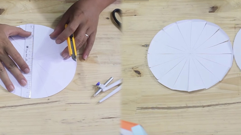 Lấy một tờ giấy trắng, đo bằng compa và cắt thành một ình tròn nhỏ hơn kích thước của lồng đèn